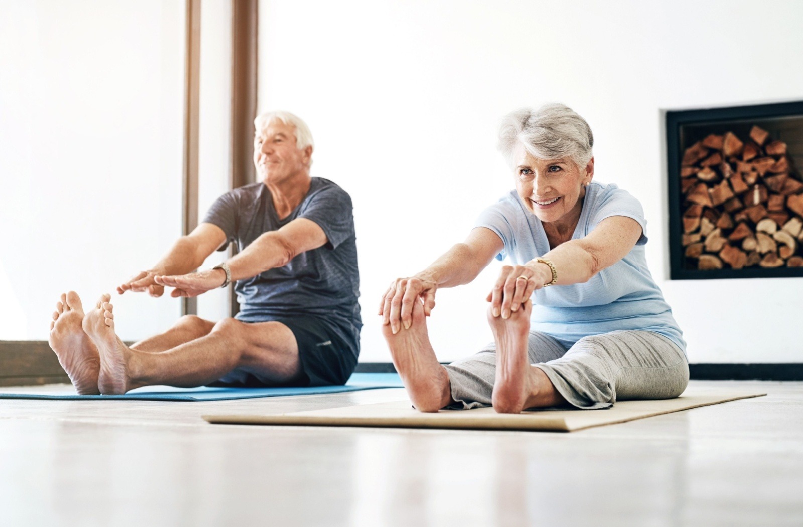 A senior couple attends a yoga class together at a senior living community.
